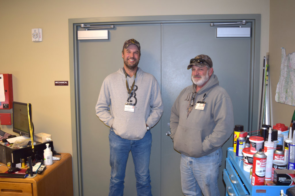 workers standing at doorway