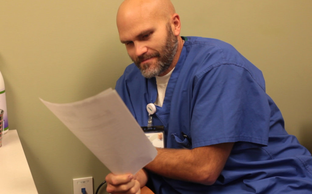 Luke Hemphill consults with pain clinic patient.